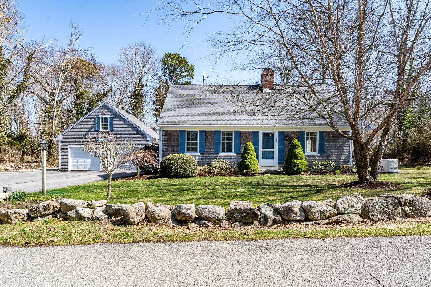 a front view of a house with a yard table and chairs
