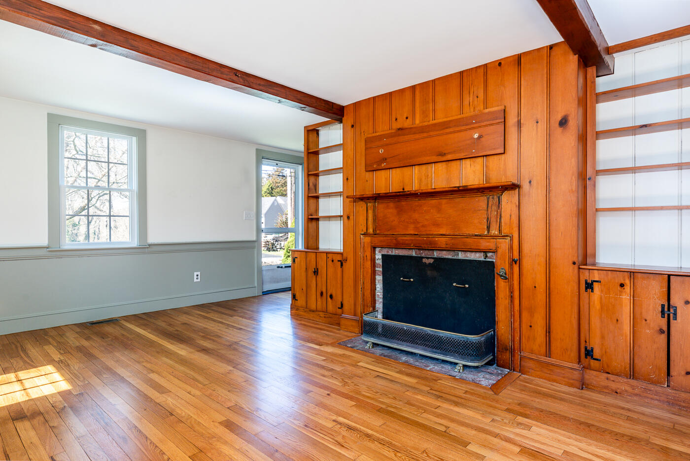 58 Pine Lane Barnstable, MA 02630 - Photo 16 of 37 an empty room with wooden floor fireplace and windows