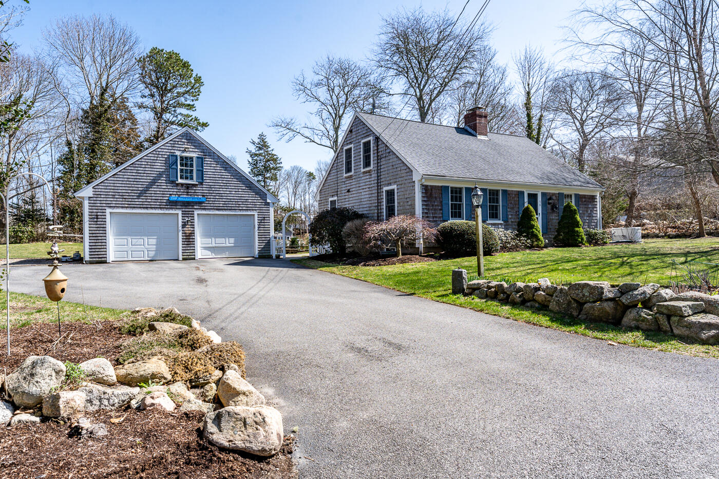 58 Pine Lane Barnstable, MA 02630 - Photo 2 of 37 a front view of a house with a yard and garage