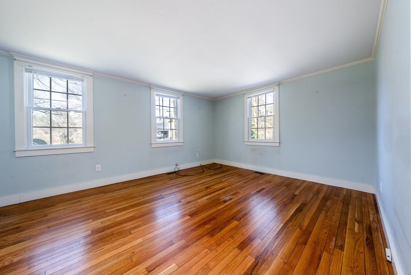 58 Pine Lane Barnstable, MA 02630 - Photo 21 of 37 a view of an empty room with wooden floor and window