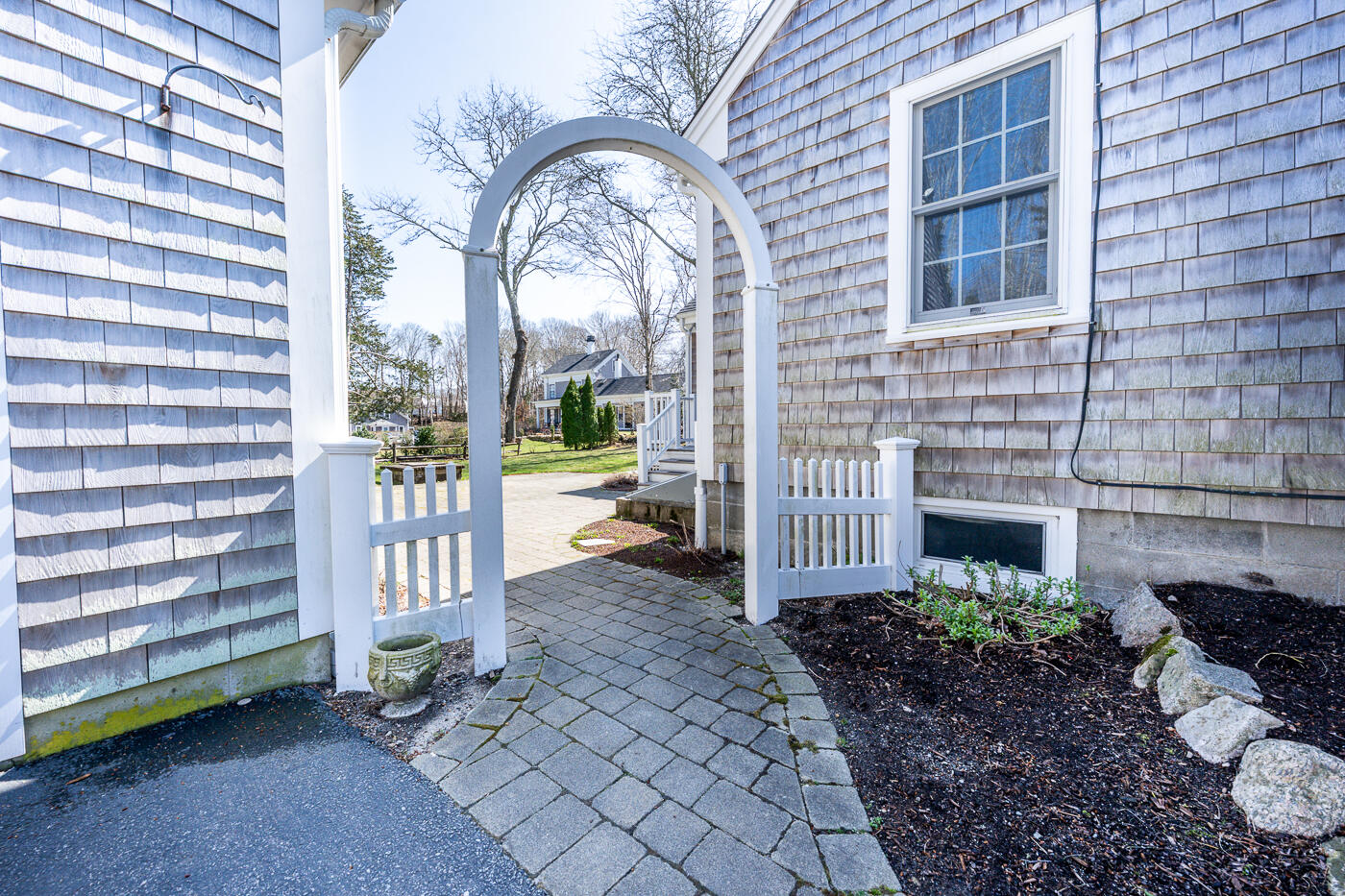 58 Pine Lane Barnstable, MA 02630 - Photo 29 of 37 a view of a porch with a bench and potted plants