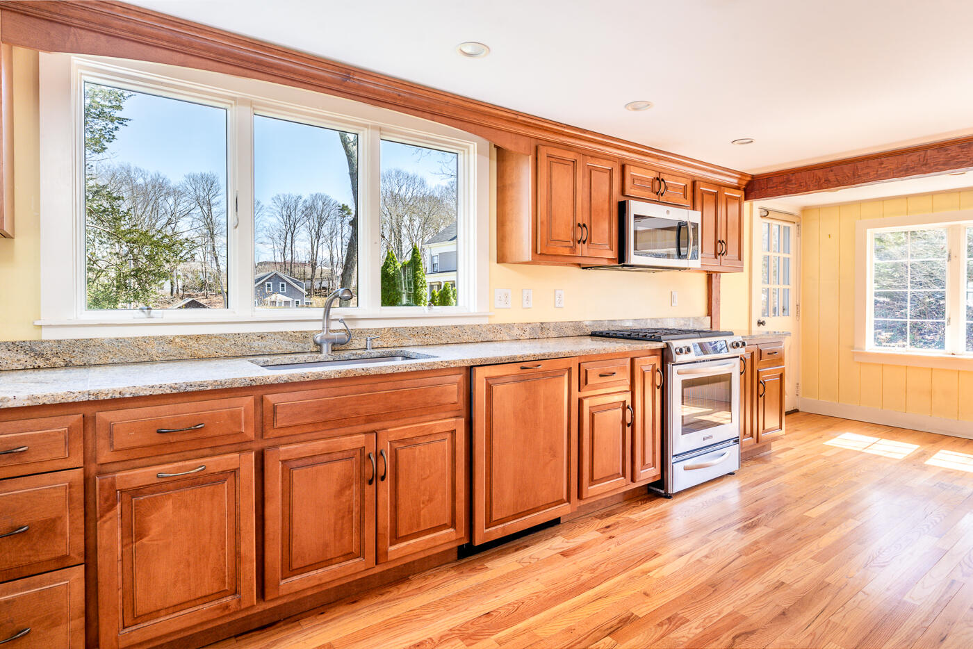58 Pine Lane Barnstable, MA 02630 - Photo 6 of 37 a large kitchen with stainless steel appliances granite countertop a stove a sink and a microwave