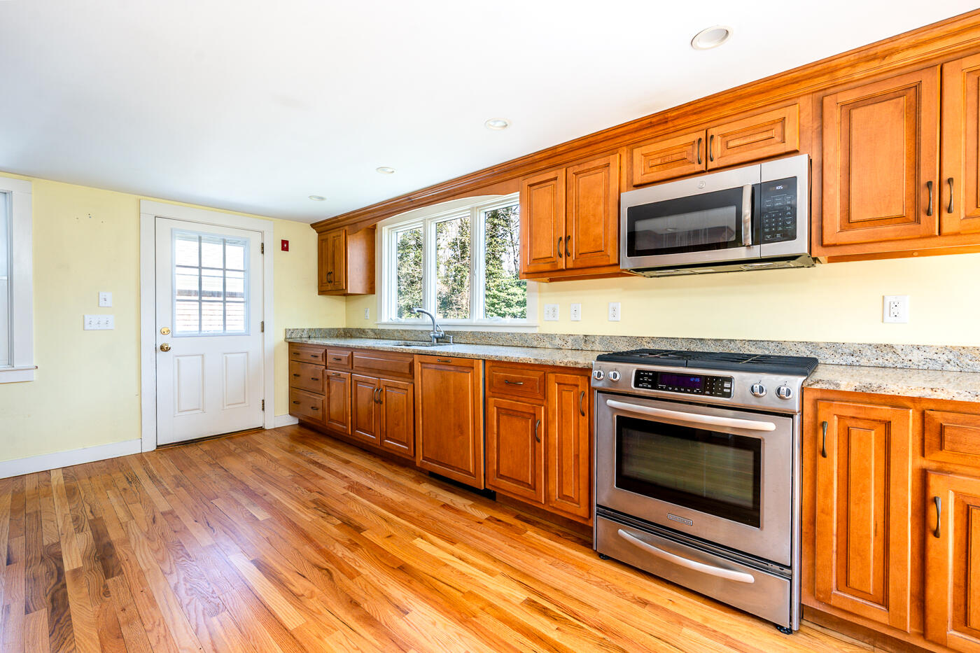 58 Pine Lane Barnstable, MA 02630 - Photo 7 of 37 a kitchen with stainless steel appliances granite countertop a stove a microwave and a sink