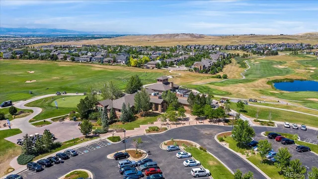 an aerial view of a city with lots of residential buildings ocean and mountain view in back