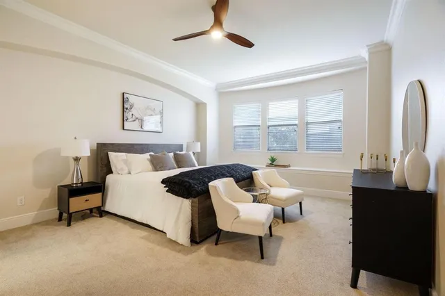 a spacious bedroom with a bed and wooden floor