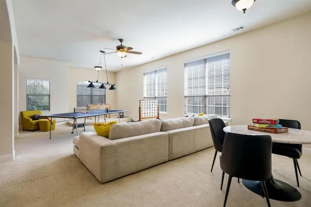 a living room with furniture a window and a chandelier