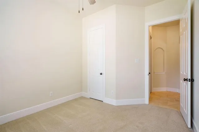 a view of a house with brick walls and a yard with plants