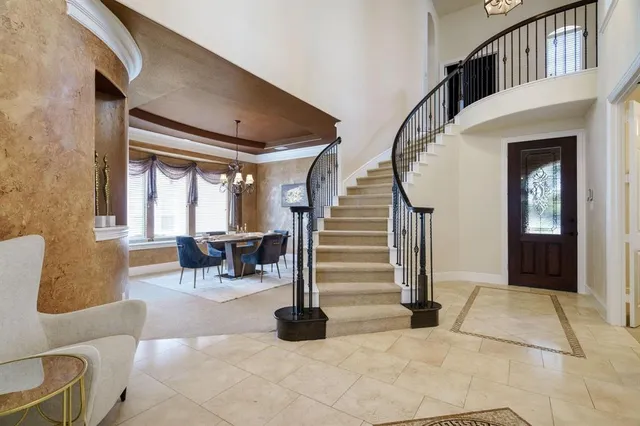 a view of a dining room with furniture and chandelier