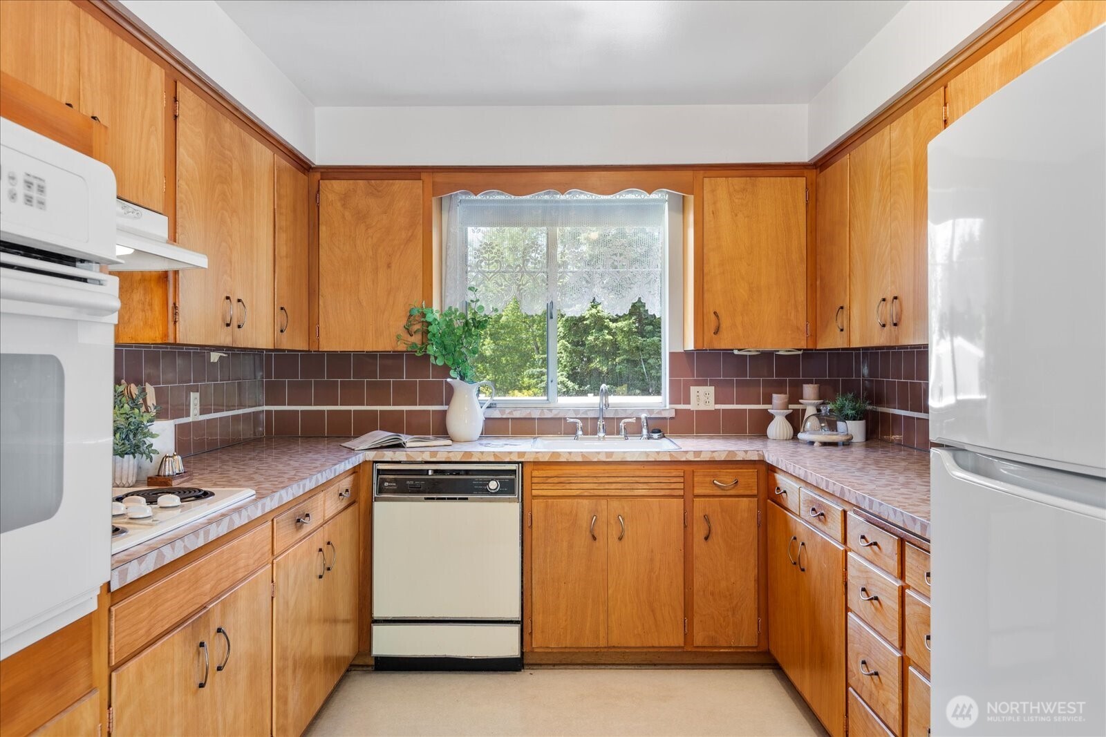 1420 Olympic Avenue Edmonds, WA 98020 - Photo 11 of 40 a kitchen with a sink stove and cabinets