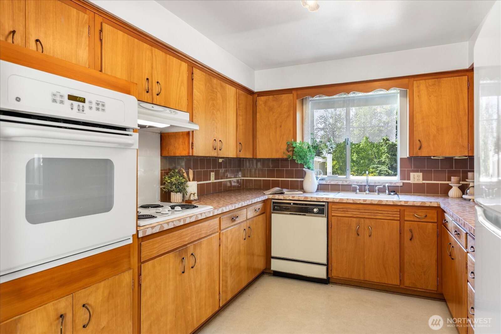 1420 Olympic Avenue Edmonds, WA 98020 - Photo 12 of 40 a kitchen with stainless steel appliances granite countertop a sink and cabinets