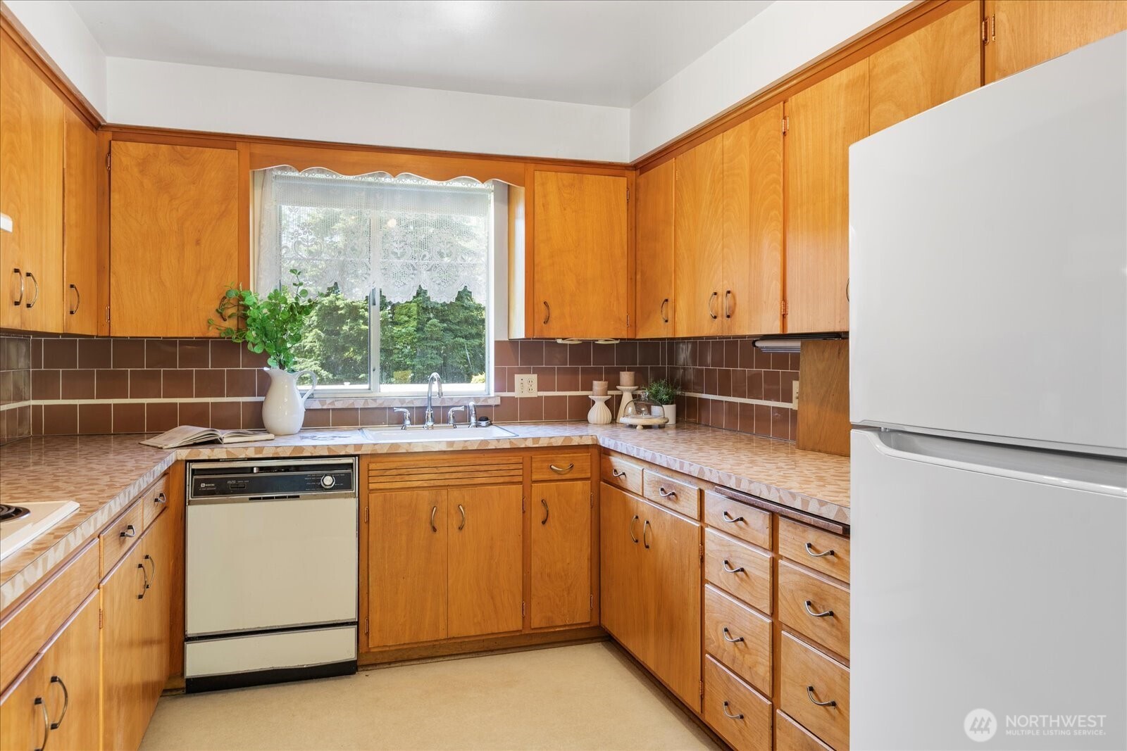 1420 Olympic Avenue Edmonds, WA 98020 - Photo 13 of 40 a kitchen with a sink and cabinets