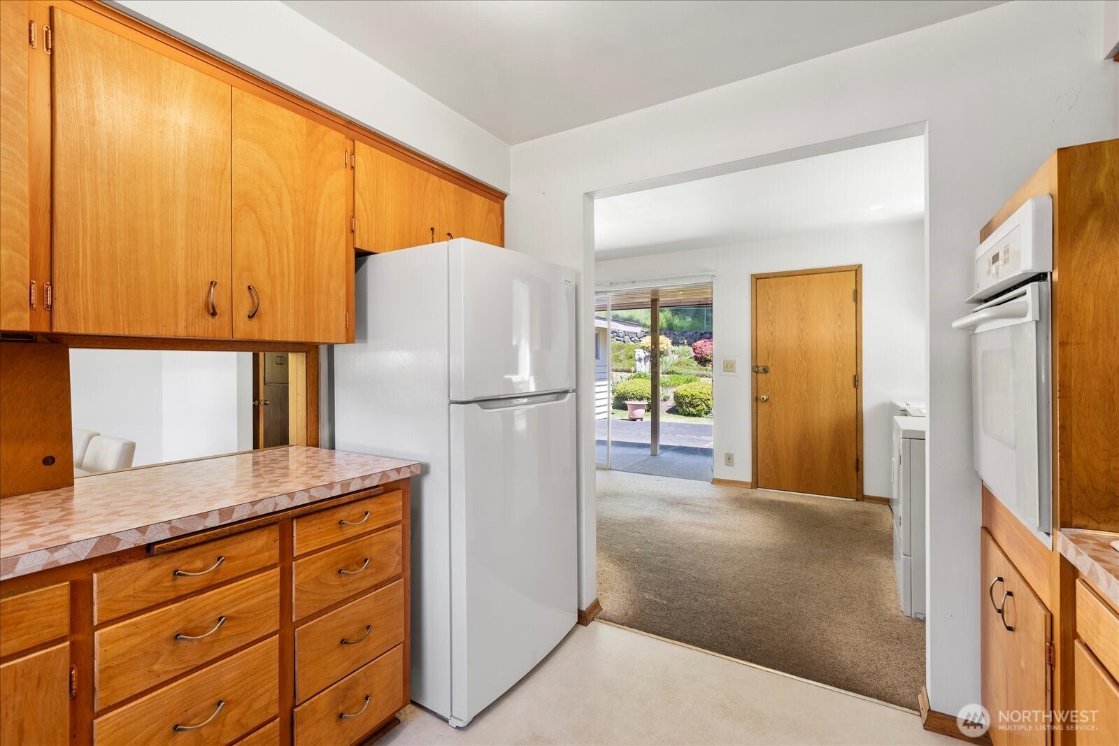 1420 Olympic Avenue Edmonds, WA 98020 - Photo 14 of 40 a kitchen with cabinets a refrigerator and a sink