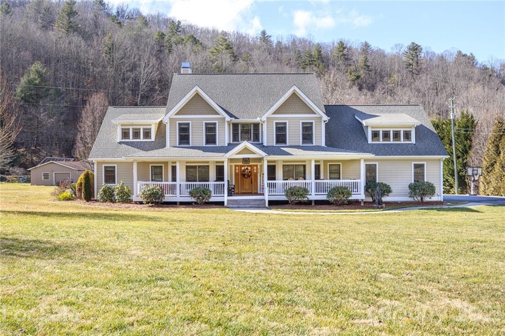 249 Ox Creek Road Weaverville, NC 28787 - Photo 1 of 32 a front view of residential houses with yard and swimming pool