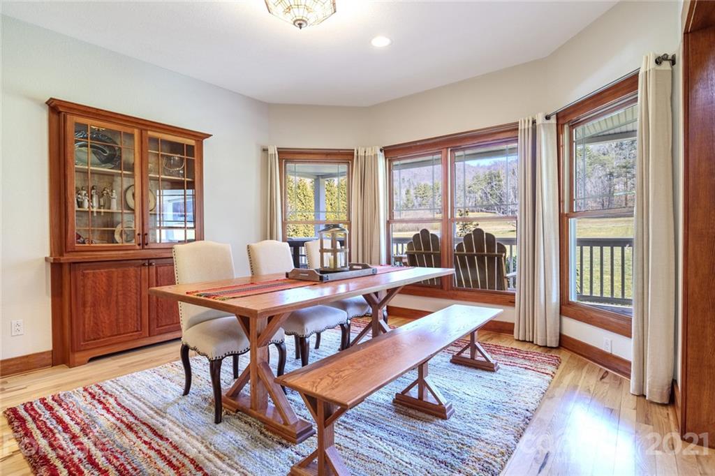 249 Ox Creek Road Weaverville, NC 28787 - Photo 13 of 32 a dining room with wooden floor and furniture