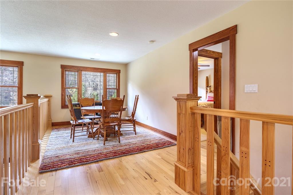 249 Ox Creek Road Weaverville, NC 28787 - Photo 14 of 32 a view of a dining room with furniture window and wooden floor
