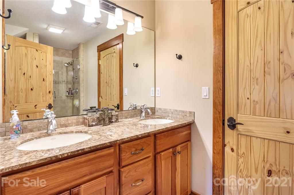249 Ox Creek Road Weaverville, NC 28787 - Photo 21 of 32 a bathroom with a granite countertop double vanity sink and mirror
