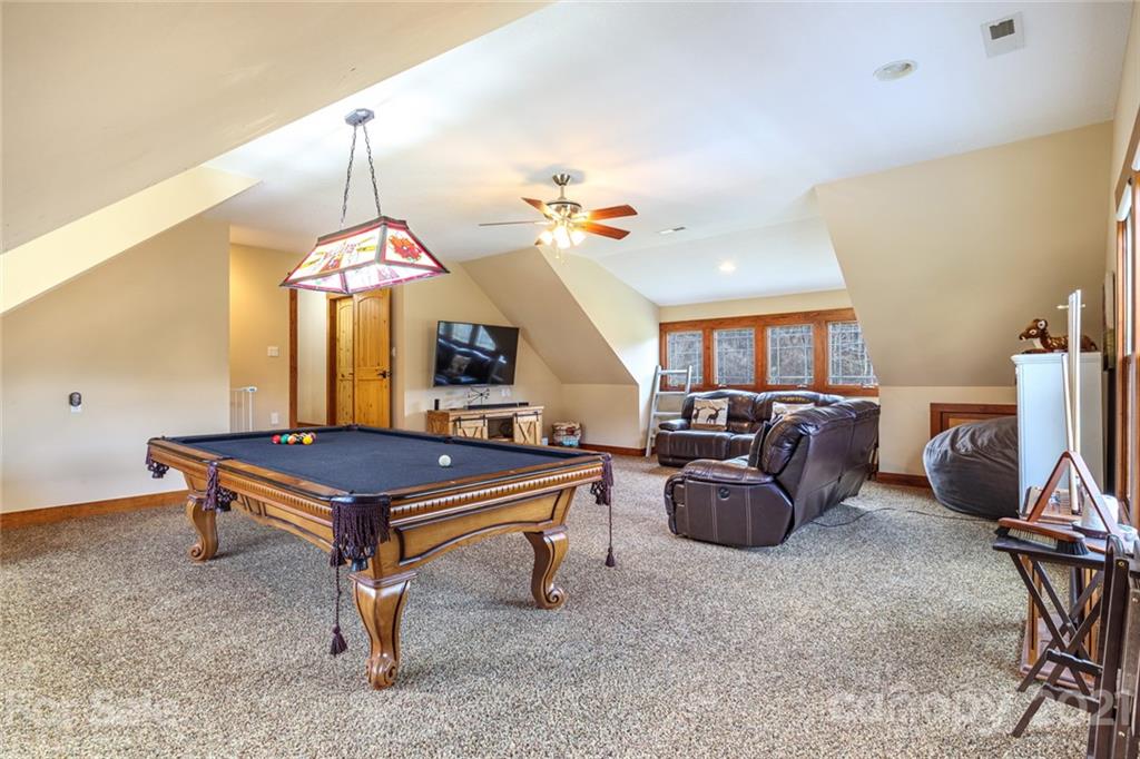 249 Ox Creek Road Weaverville, NC 28787 - Photo 22 of 32 a living room with furniture a chandelier and a piano