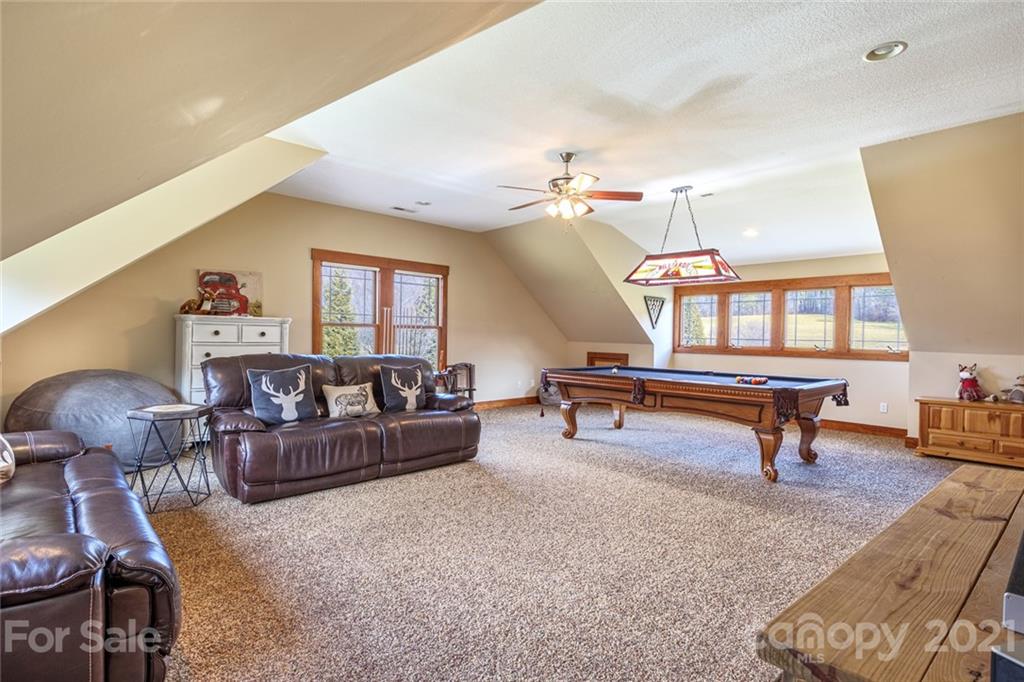 249 Ox Creek Road Weaverville, NC 28787 - Photo 23 of 32 a living room with furniture and a wooden floor
