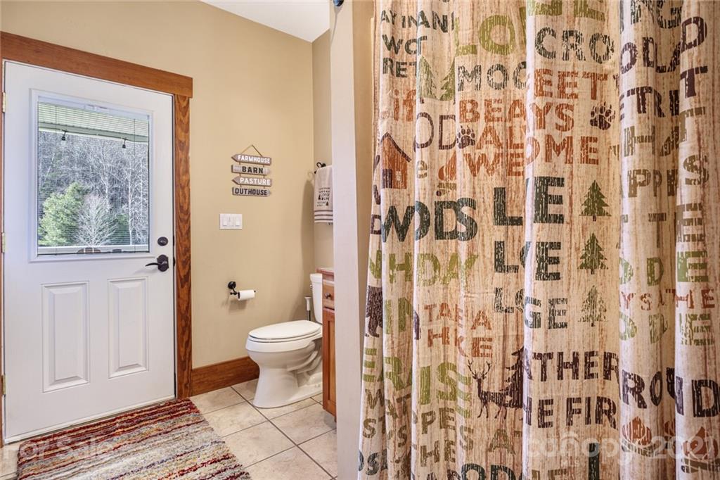249 Ox Creek Road Weaverville, NC 28787 - Photo 25 of 32 a bathroom with a toilet and a shower curtain