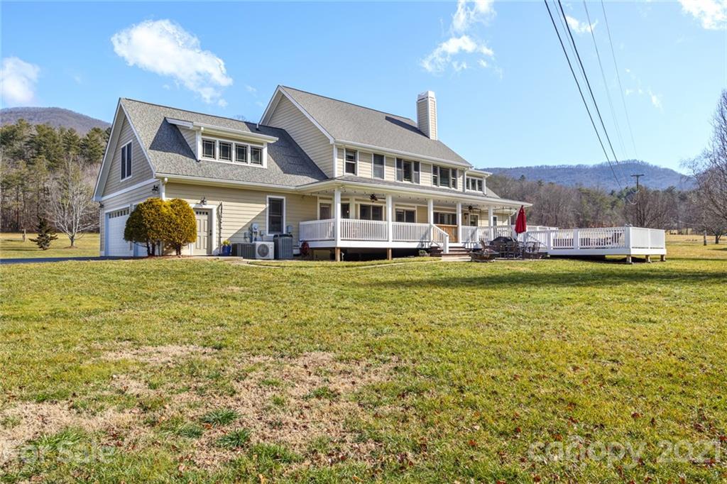 249 Ox Creek Road Weaverville, NC 28787 - Photo 26 of 32 a front view of a house with a garden and lake view