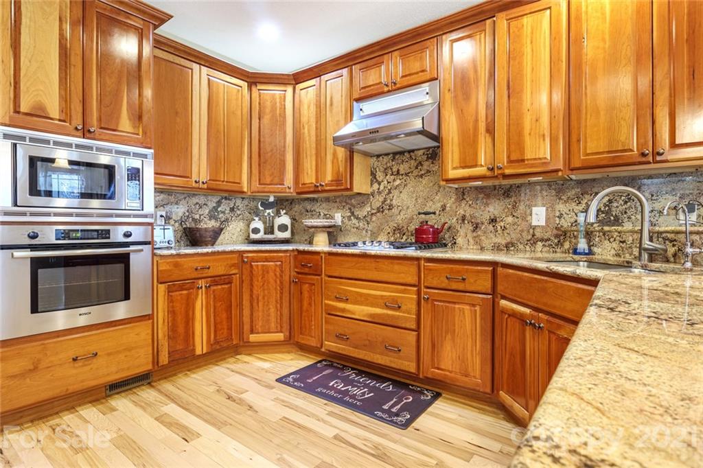 249 Ox Creek Road Weaverville, NC 28787 - Photo 6 of 32 a kitchen with stainless steel appliances granite countertop a stove a sink and a microwave