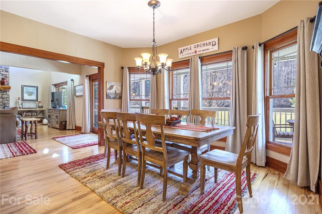 249 Ox Creek Road Weaverville, NC 28787 - Photo 7 of 32 a view of a dining room with furniture window and wooden floor