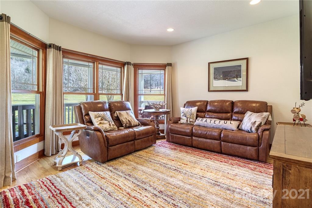 249 Ox Creek Road Weaverville, NC 28787 - Photo 8 of 32 a living room with furniture and a floor to ceiling window