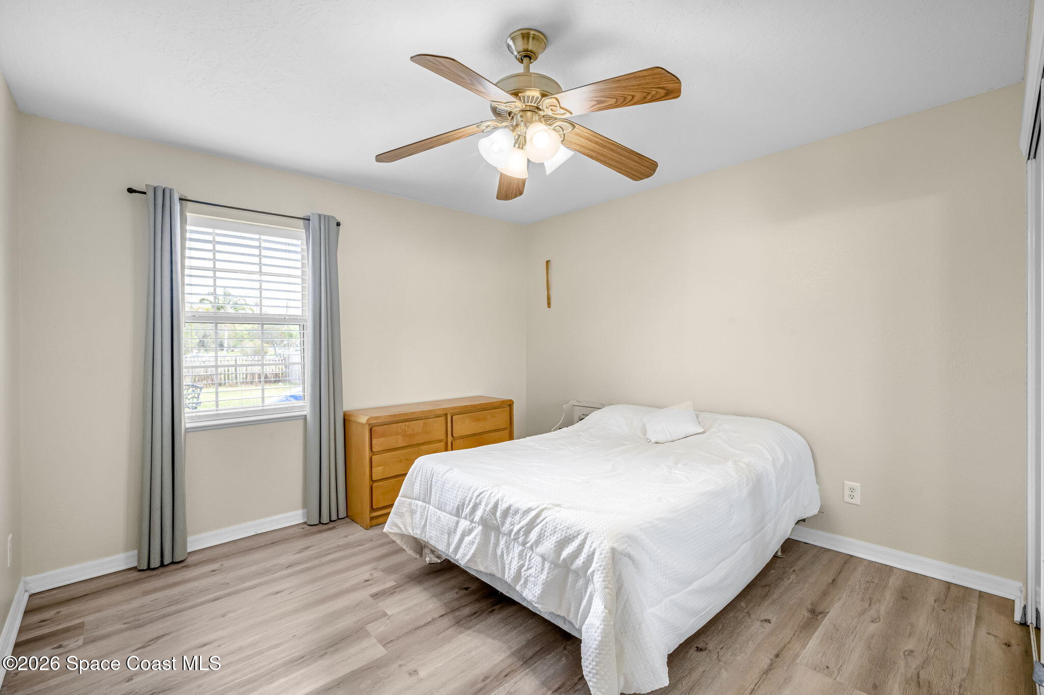 3404 Kilbee Street Mims, FL 32754 - Photo 21 of 30 a bedroom with a bed and a window
