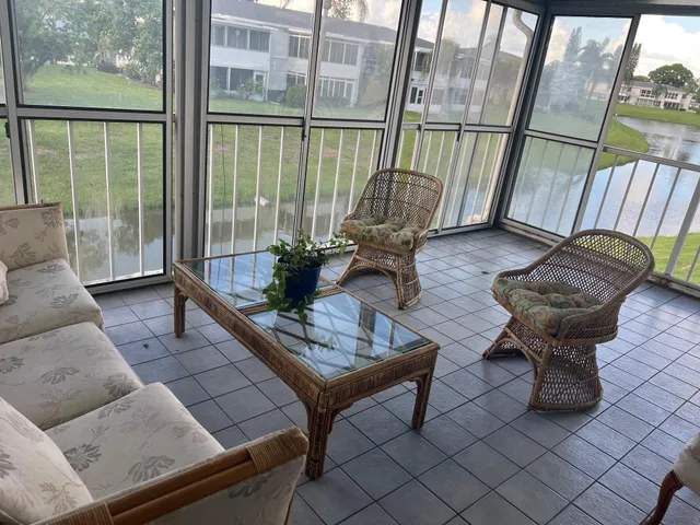 a living room with furniture and a floor to ceiling window