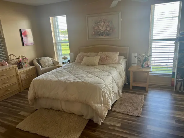 a bed sitting in a bedroom next to a window