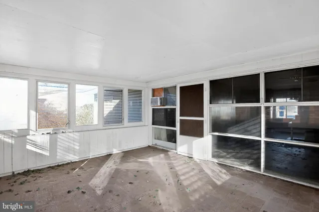 an empty room with a empty space and windows