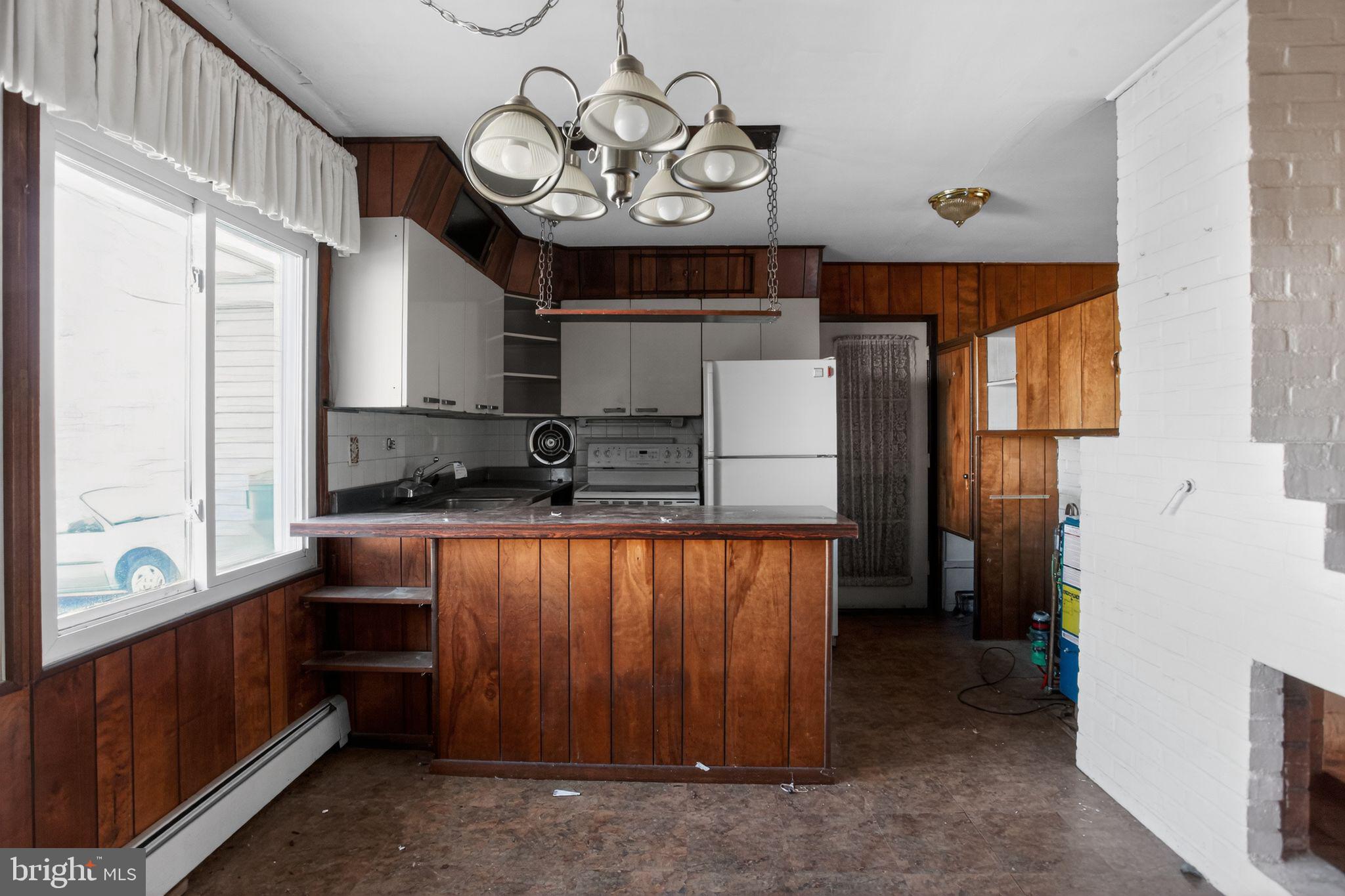 6 Field Lane Levittown, PA 19055 - Photo 10 of 20 a kitchen with stainless steel appliances granite countertop a refrigerator a sink dishwasher a stove and a dining table with wooden floor