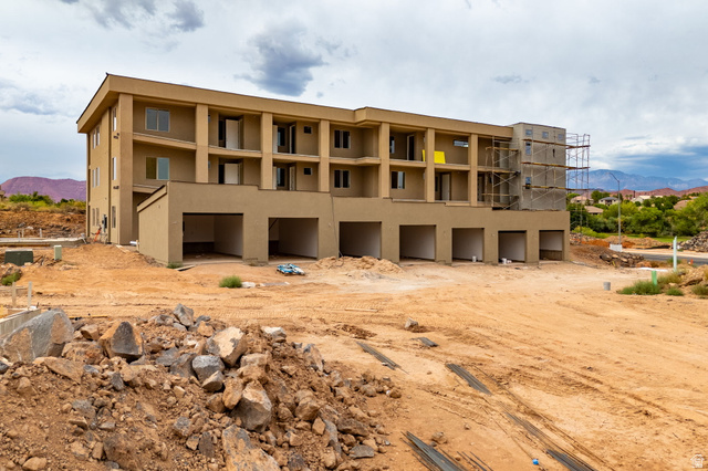 271 North Country Lane, Unit 60 St. George, UT 84770 - Photo 9 of 17 Rear view of house featuring a mountain view and stucco siding