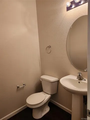 a white toilet sitting next to a bathroom sink