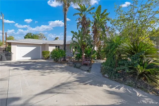 a view of a patio with table and chairs and potted plants