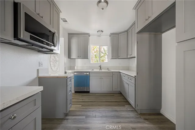 a kitchen with a sink cabinets and microwave