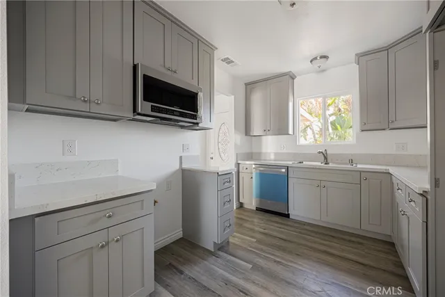 a kitchen with a sink stove and microwave
