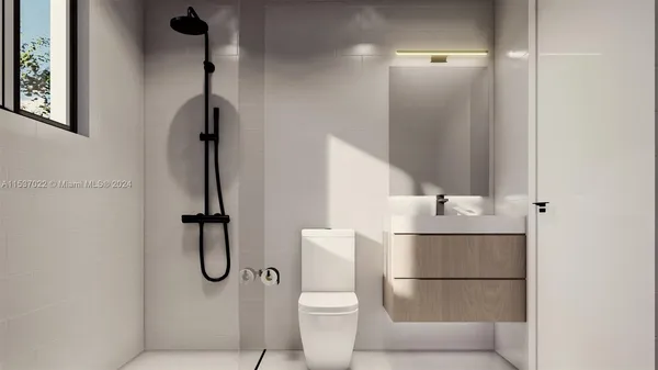 a bathroom with a toilet and a shower