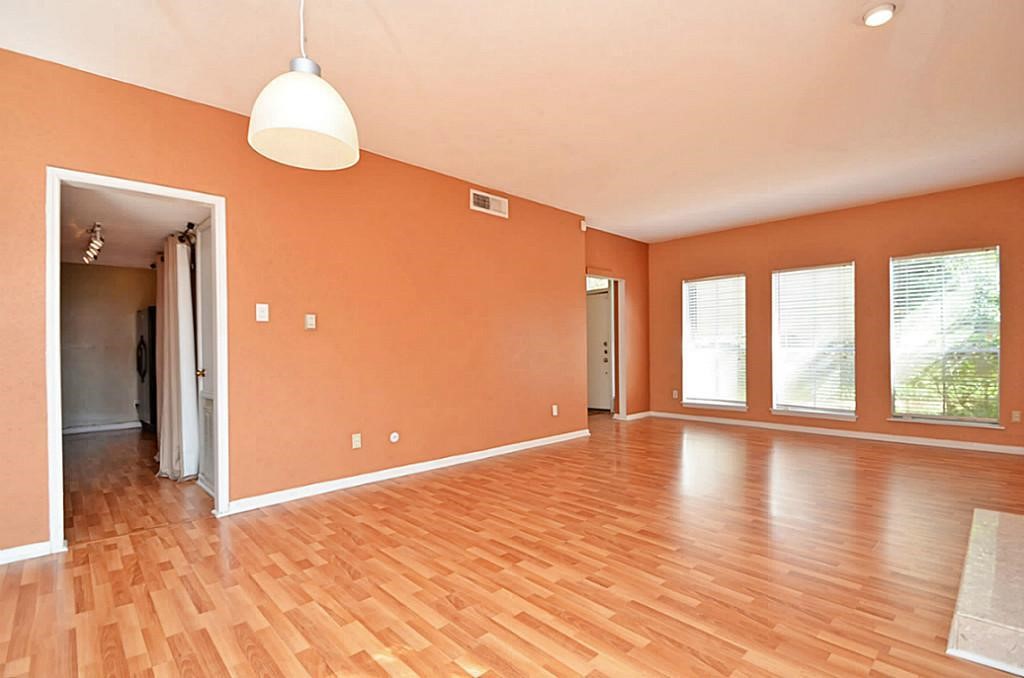 2100 Tanglewilde Street, Unit 351 Houston, TX 77063 - Photo 11 of 12 a view of an empty room with wooden floor and a window