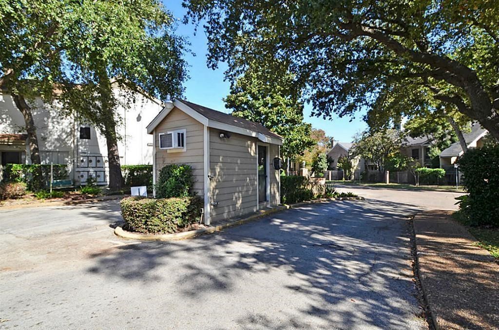 2100 Tanglewilde Street, Unit 351 Houston, TX 77063 - Photo 2 of 12 a view of a house with a small yard plants and large tree