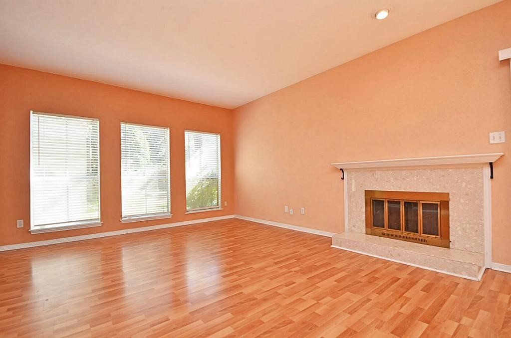 2100 Tanglewilde Street, Unit 351 Houston, TX 77063 - Photo 9 of 12 a view of an empty room with wooden floor fireplace and a window