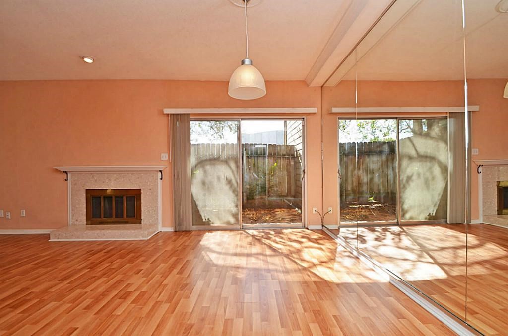 2100 Tanglewilde Street, Unit 351 Houston, TX 77063 - Photo 10 of 12 a view of a livingroom with wooden floor and a fireplace