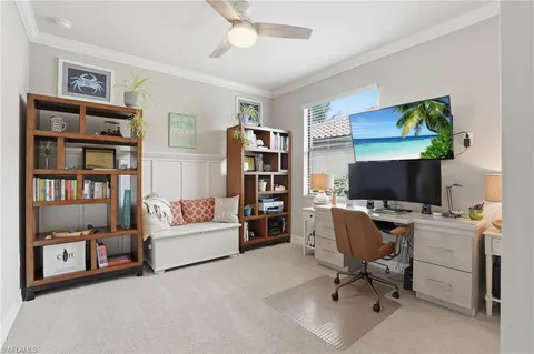 a view of a livingroom with workspace and a window