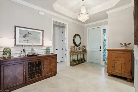 a living room with furniture and a mirror