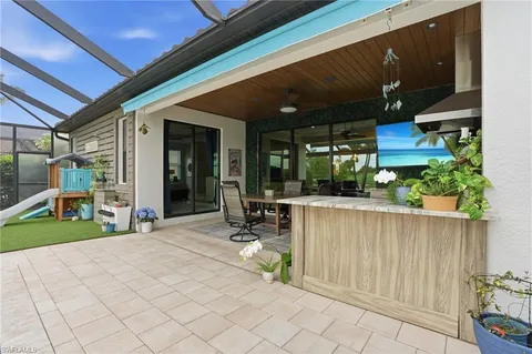 a view of a house with backyard porch and sitting area