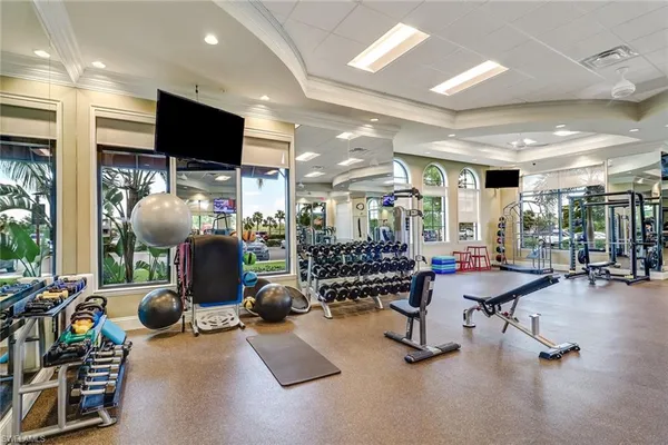 a room with gym equipment and a flat screen tv
