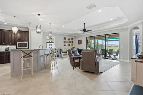a living room with lots of furniture and a large window