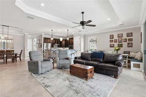 a living room with furniture and kitchen view