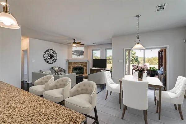 a living room with furniture a fireplace and a chandelier