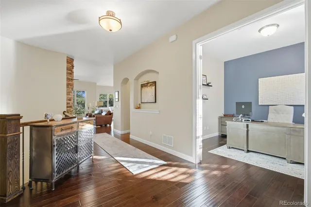 a view of a living room filled with furniture and wooden floor